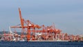 unloading shipping containers by crane off of container ships in in the port of Vancouver, British Columbia, Ca Royalty Free Stock Photo