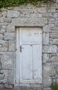 An old white door embedded in an old stone wall Royalty Free Stock Photo