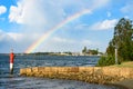 Port Macquarie, a colorful rainbow in the cloudy sky over the Hastings River, view from the kayak pier after heavy rain