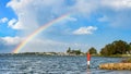 Port Macquarie, a colorful rainbow in the cloudy sky over the Hastings River, view from the kayak pier after heavy rain