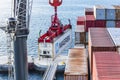 Suspended container marked Maersk being unloaded from a cargo ship. Royalty Free Stock Photo