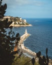 Port of Nice view through the cactuses. Lighthouse in the south coast of France. Azur sea Royalty Free Stock Photo