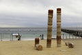 Port Noarlunga Beach with Jetty and Guildhouse art statue, ominent. Beach and Jetty in the Background. Royalty Free Stock Photo