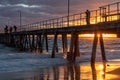 The port noarlunga jetty with a sub burst at sunset in south australia on April 19th 2021 Royalty Free Stock Photo