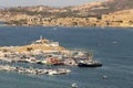 The port of old Foca in TR: Eski foca limani with lots of yachts and fishing boats parked. The lighthouse is also visible and Royalty Free Stock Photo