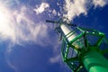 Port radar for navigation in the harbor against blue cloudy sky and sun rays