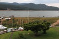 Port of small and large sailboats parked and sailing on the lake of Valle de Bravo in Mexico at sunset