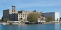 Derelict factories stand unused by the riverside. Large concrete shut down manufacturing plant