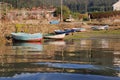 A port with several wooden boats stranded on the beach