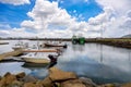 Port in a small village in the Icelandic countryside with several boats moored Blue sky and beautiful clouds reflected in the Royalty Free Stock Photo