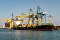 Container ship under flag of Liberia being loaded with containers and cargo in port in Port Sudan. Royalty Free Stock Photo