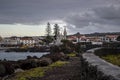 Port town with white church on a lava coast of the island of Pico