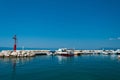 Port of Tucepi with ships and lighthouse. Croatia Royalty Free Stock Photo