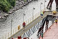 Port of Vancouver, WA, USA. August,21, 2020. Shore dockers work on the berth with ship ropes during the mooring operation of a bul