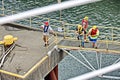 Port of Vancouver, WA, USA. August,21, 2020. Shore dockers work on the berth with ship ropes during the mooring operation of a bul