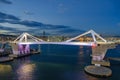 Port Vell with its bridge Porta d`Europa and the aerial tramway tower Torre Jaume I in Barcelona at night