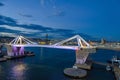 Port Vell with its bridge Porta d`Europa and the aerial tramway tower Torre Jaume I in Barcelona at night Royalty Free Stock Photo