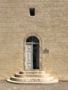 An old door with arched window directly above; in Port Vendres, France.