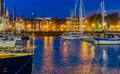 The port of Vlissingen at night, decorated ships with lights, lighted city buildings with water, popular city in zeeland, The Royalty Free Stock Photo