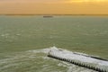 The port of vlissingen at sunset with a boat sailing by, landscape of a wild sea, Zeeland, The Netherlands Royalty Free Stock Photo