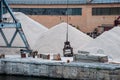 Port work: loading and unloading large piles of sand