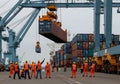 Port workers handling cargo containers Royalty Free Stock Photo