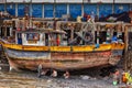 Port workers repair a fishing boat in the fishing port of Panama City. Royalty Free Stock Photo