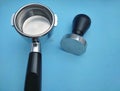 porta filter and tamper barista equipment on blue background Royalty Free Stock Photo