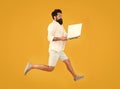 Portability concept. Remote job. Man inspired hold laptop jump. Run with laptop. Hipster bearded manager with laptop