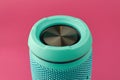 Portable audio speaker subwoofer, close-up. Turquoise Wireless speaker on a pink background Royalty Free Stock Photo