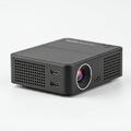 A portable black projector with a cubic shape, featuring a prominent lens on the front. Royalty Free Stock Photo