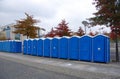 A row of portable rent toilets Royalty Free Stock Photo