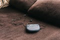 Portable cd player known as discman leaning on sofa at home