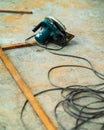 Portable circular saw tool with long wires to cut wood in a construction site Royalty Free Stock Photo