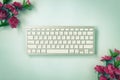 Portable Computer Keyboard and Rose Flower at Top Left and Bottom Right Corner in Vintage Tone Royalty Free Stock Photo