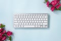 Portable Computer Keyboard and Rose Flower at Top Right and Bottom Left Corner Royalty Free Stock Photo