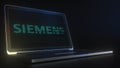 Portable computer with the logo of SIEMENS made with code strings, editorial conceptual 3d rendering