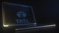 Portable computer with the logo of TATA made with code strings, editorial conceptual 3d rendering