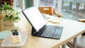 A portable digital tablet touchpad mockup on the table in cafe coffee shop