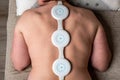 Portable and easy to use physiotherapy device for the magnetic therapy at home. Electrotherapy for back pain in women
