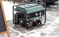 Portable electric generator running in the cold winter.Energy genocide. Power outage as a result of missile strikes by Russia on Royalty Free Stock Photo