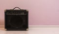 Portable electric guitar amplifier isolated in front of a stone wall, music equipment background Royalty Free Stock Photo