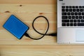 Portable external hard drive USB3.0 connect to laptop computer on wooden Royalty Free Stock Photo