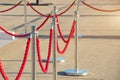 Portable fencing barrier outside. Red carpet safety rope