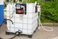 Portable fuel tank with pipes, pump and measuring meter. Mini portable diesel storage tank station