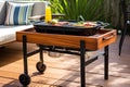 portable grill with attached side table for easy grilling and serving