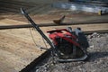 Portable hand-held compacting machine. Development of the territory in the national park. Royalty Free Stock Photo