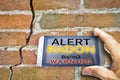 Portable information device for monitoring radioactive gas radon - radon testing concept image against a cracked wall