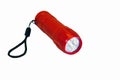 Portable LED flashlight red color isolate on a white background. Close-up