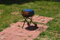 Portable outdoor bbq grill equipment in a garden under the sunlight